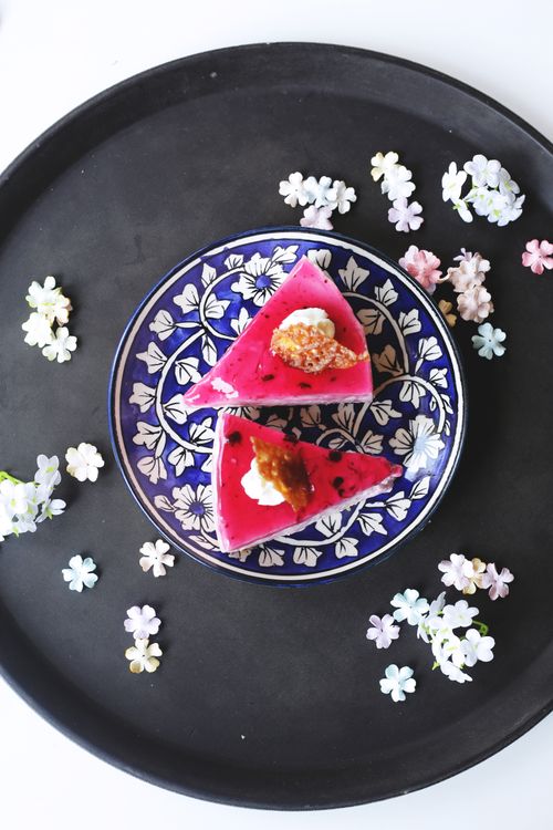 Free Elegant slices of vibrant dessert with floral decorations on a decorative plate. Stock Photo