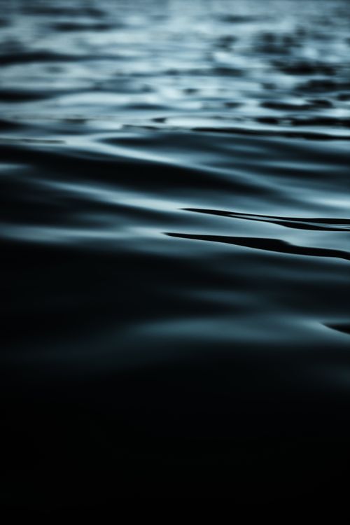 Free Close-up of dark rippling water surface, perfect as a minimalist background. Stock Photo