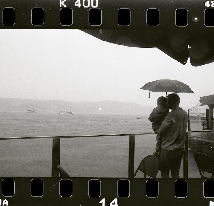 Man With Child On Sea Shore In Istanbul On Photographic Film