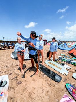 Group learning kitesurfing at sunny Adicora Beach, Venezuela.