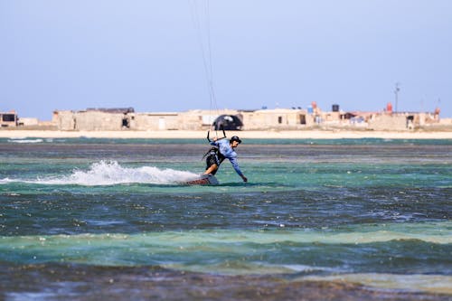 Man Kitesurfing on the Sea 