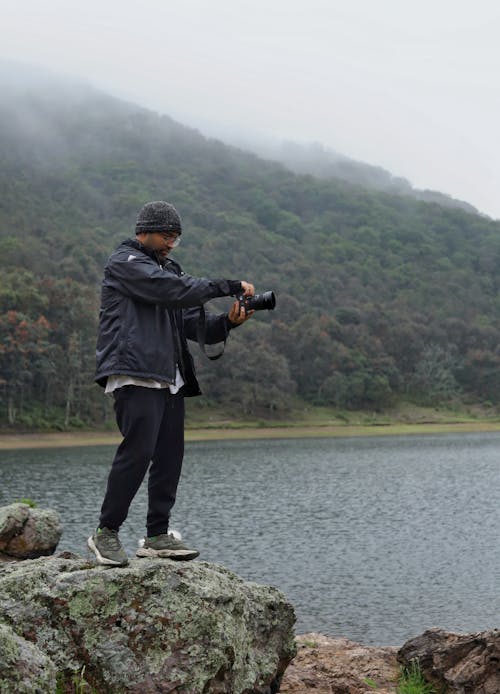 A Man Taking Photo of the Lake