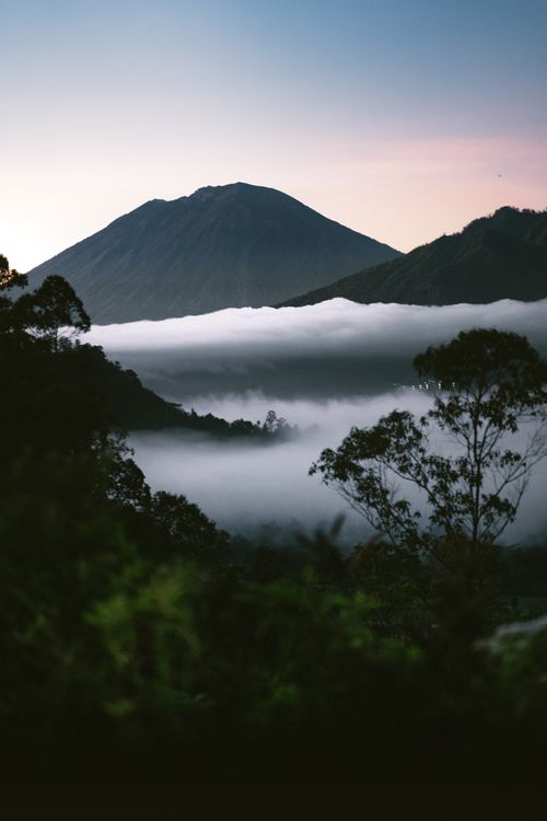 Free Breathtaking view of misty mountains and lush nature in Bali, Indonesia at dawn. Stock Photo