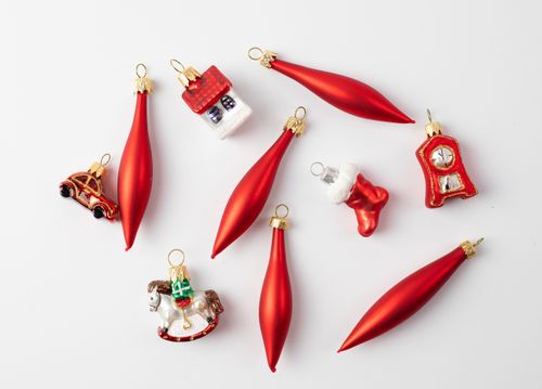 Free A collection of vibrant red Christmas ornaments on a white surface, including various shapes and designs. Stock Photo