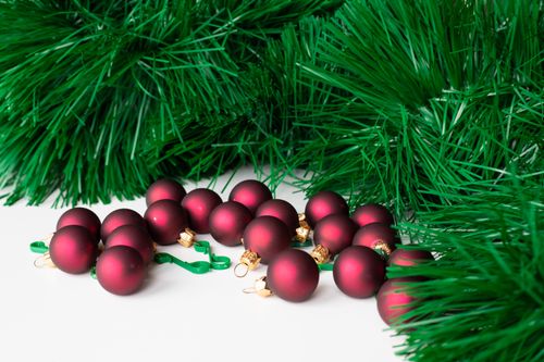 Free Close-up of red Christmas balls surrounded by green artificial pine branches. Stock Photo