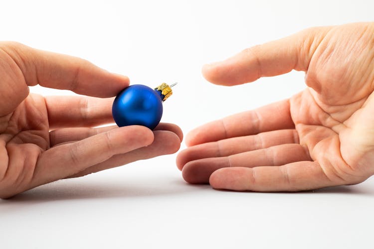 Hands With A Christmas Ornament 