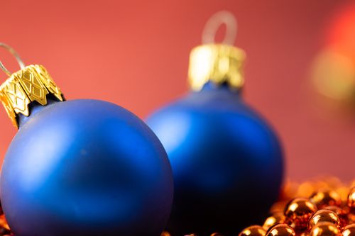 Free Close-up of blue and gold Christmas ornaments on a festive backdrop. Stock Photo