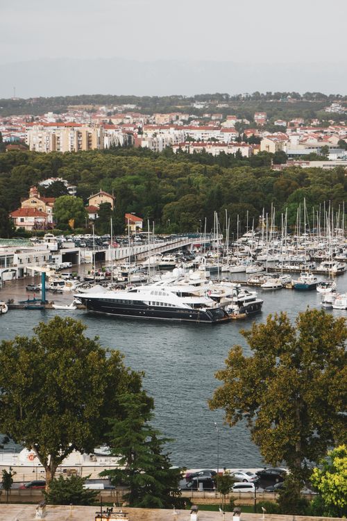 Free Stunning aerial view of a bustling marina in Zadar, Croatia, surrounded by lush greenery. Stock Photo