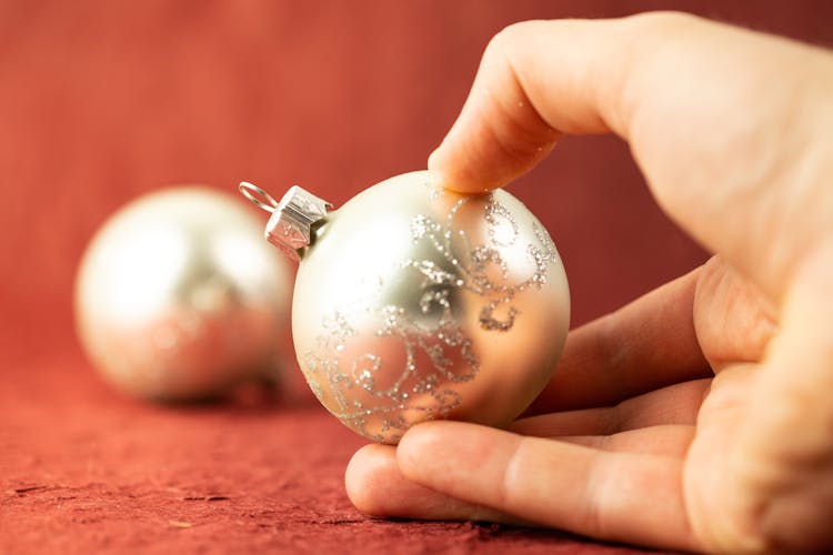 Hand Holding Christmas Glass Ball