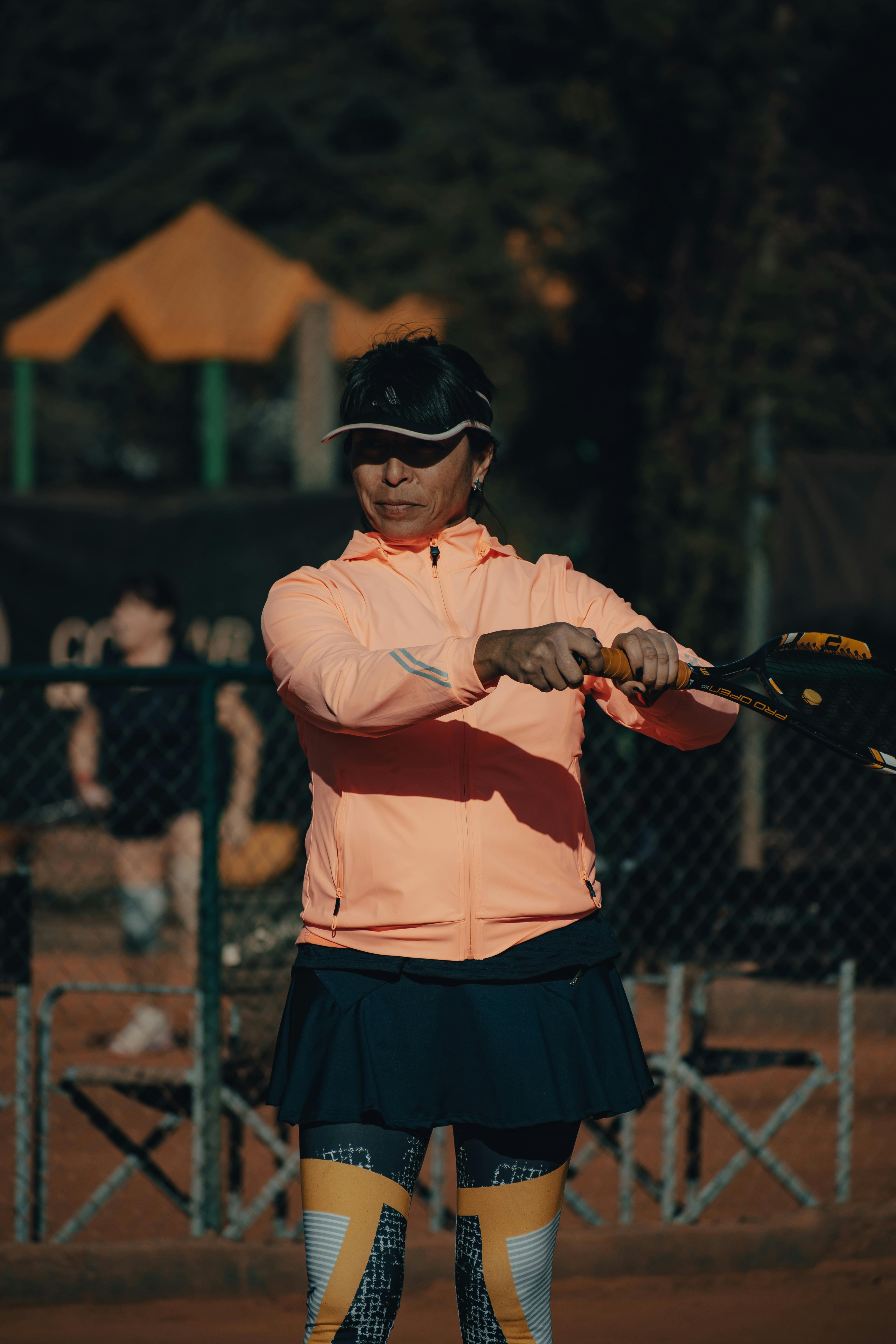 Woman Wearing Sports Bra Holding a Racket · Free Stock Photo