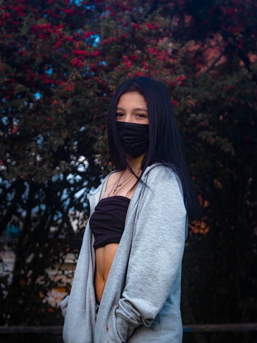 Woman Wearing Face Mask and Crop Top in Park