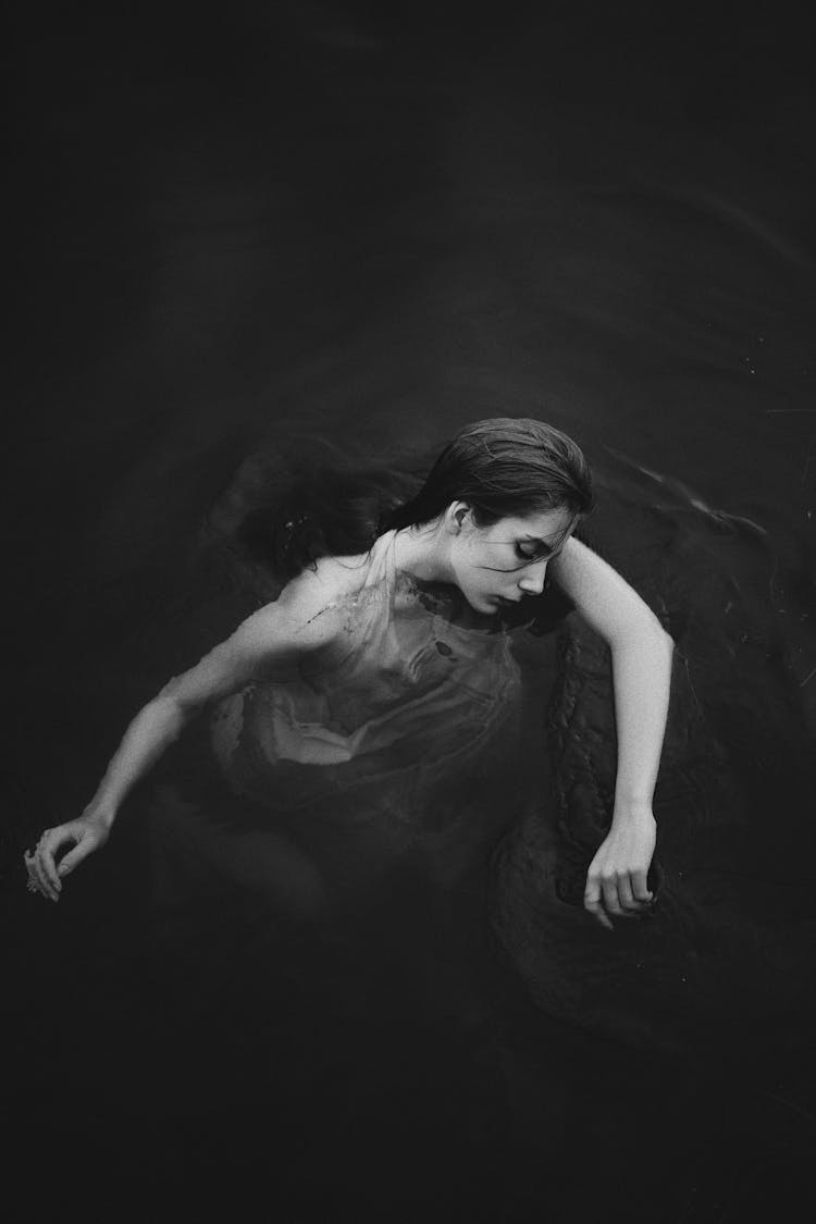 Woman Floating On The Water Surface 