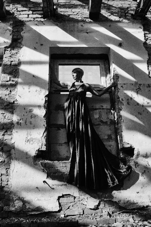 Woman Posing in an Elegant Dress in Front of an Old Weathered Door