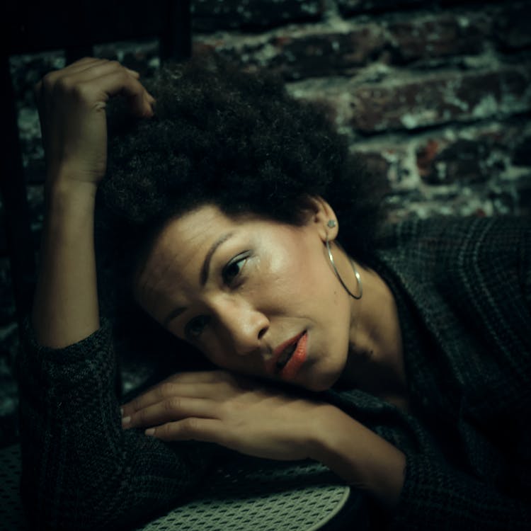 Portrait Of Woman Lying Head On Table