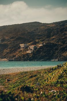 Scenic view of beach houses on a hillside at Arraial do Cabo, Brazil under a serene sky.