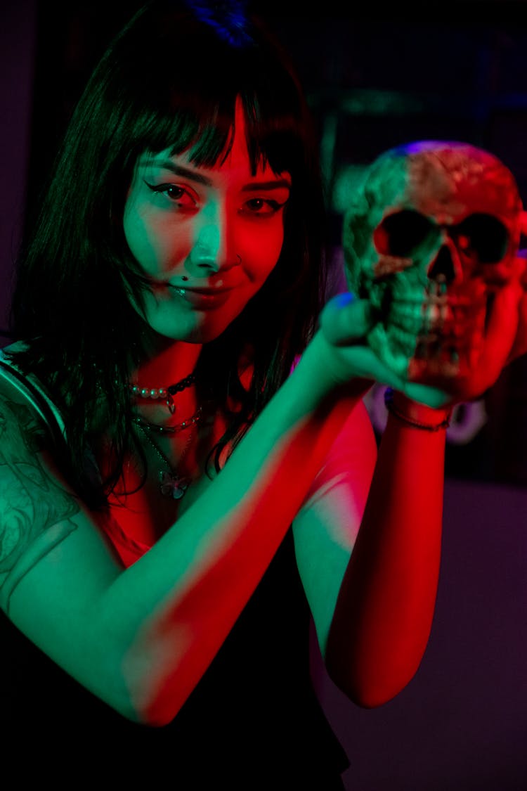 Close-up Photo Of An Edgy Woman Holding A Skull 