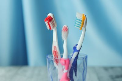 Trio of vibrant toothbrushes in a glass — photo by Towfiqu barbhuiya on Pexels