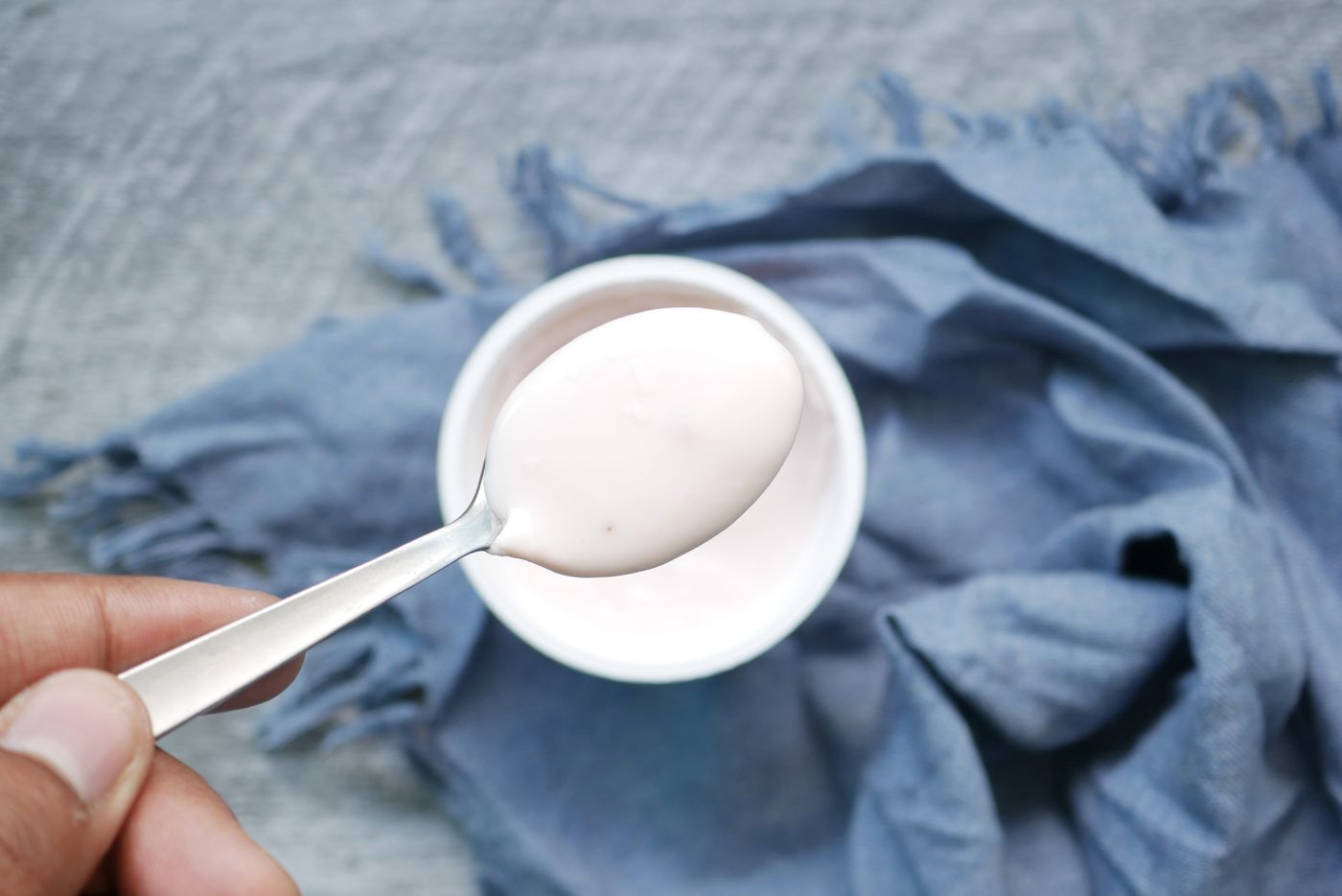 Plain yogurt on a spoon illustrating the yogurt food matrix