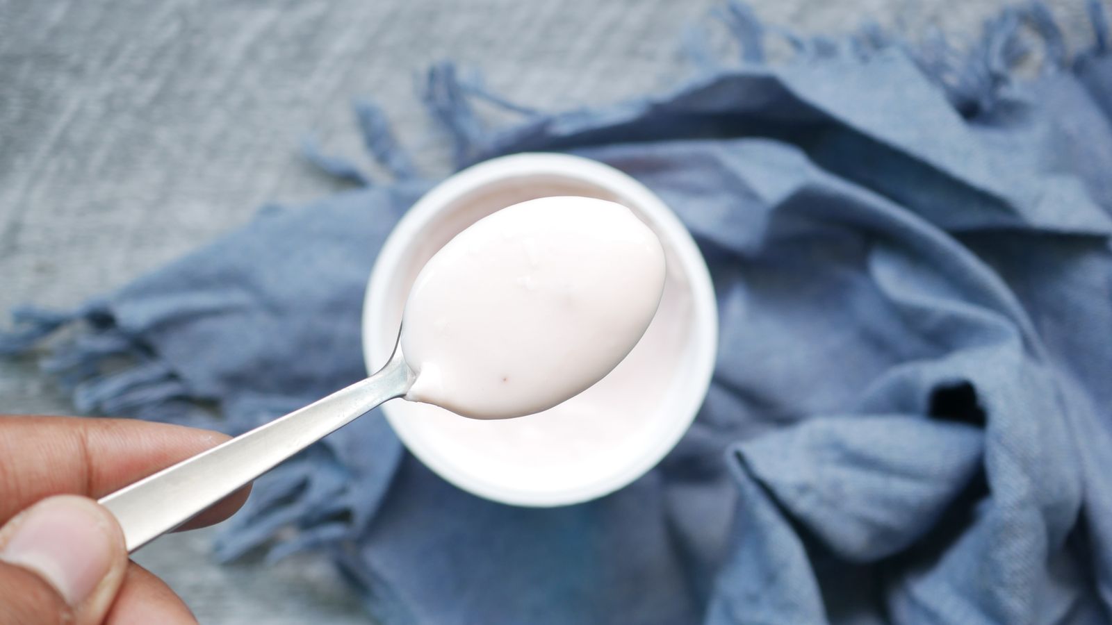 A hand holding a spoon with plain yogurt above a bowl — photo by Towfiqu barbhuiya on Pexels A hand holding a spoon with plain yogurt above a bowl