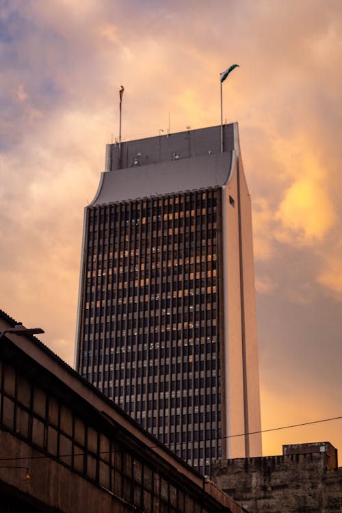 Gray Concrete Building Under Orange Sky