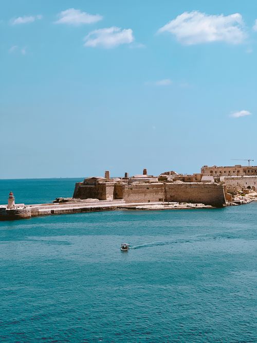 Free Explore a stunning medieval fortress by the sea under a clear blue sky in Malta. Stock Photo