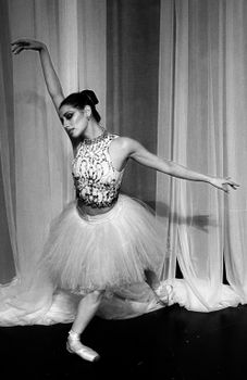 Elegant black-and-white portrait of a ballet dancer performing with poise.