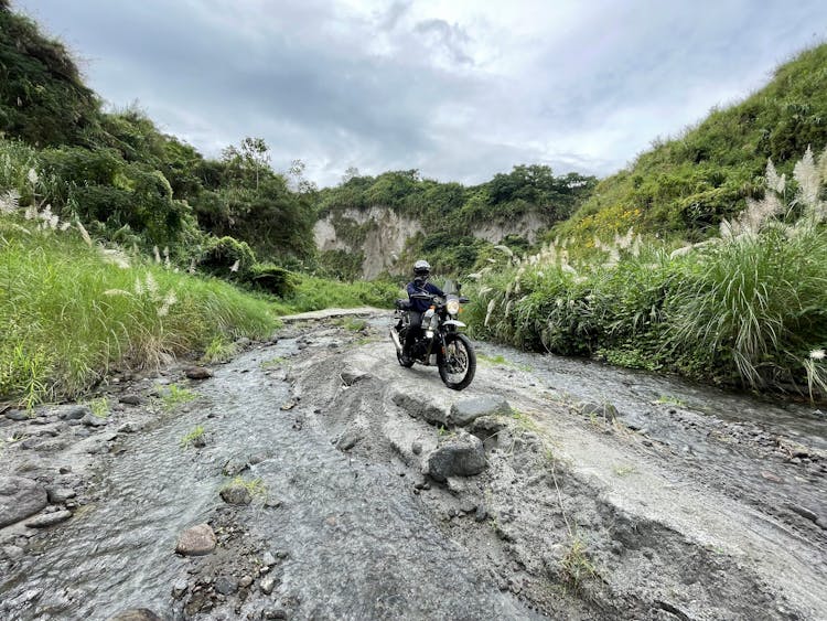 A Man Riding Motorbike On Dirt Road