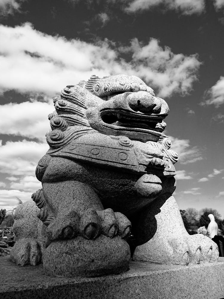 Concrete Statue Under Cloudy Sky