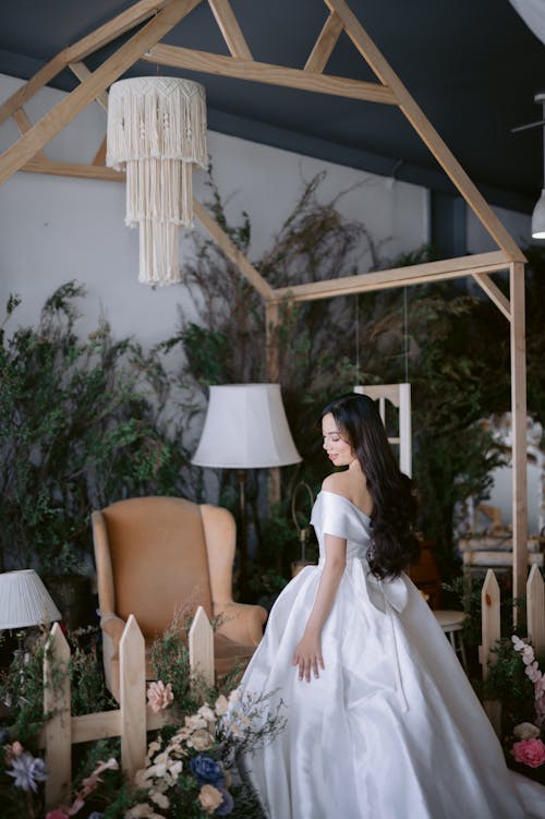 Woman in White Wedding Dress Posing near the Decorations