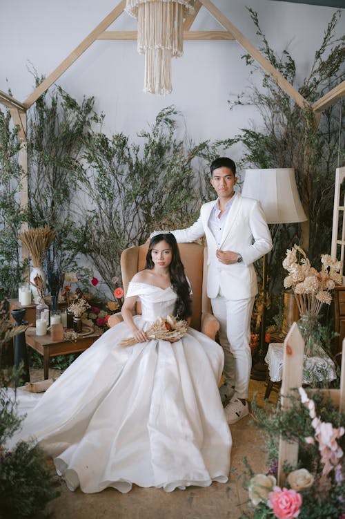 Man in White Suit and Woman in White Wedding Dress