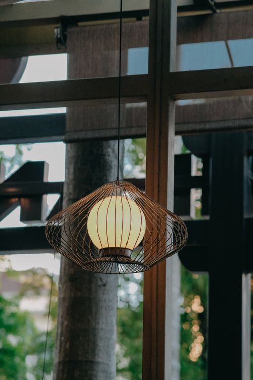 Free Contemporary pendant lamp suspended in a minimalist interior, adding elegance and style. Stock Photo