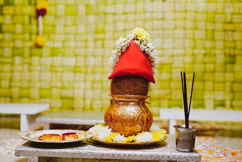 Free Vibrant traditional Indian Kalash with floral decorations for ceremonial rituals on a decorated table. Stock Photo