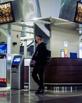 A man wearing a mask at an airport check-in counter during the pandemic.
