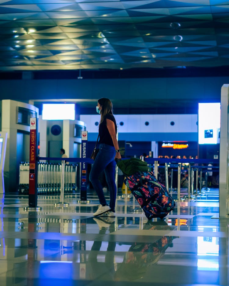 Woman With Luggage At Airport