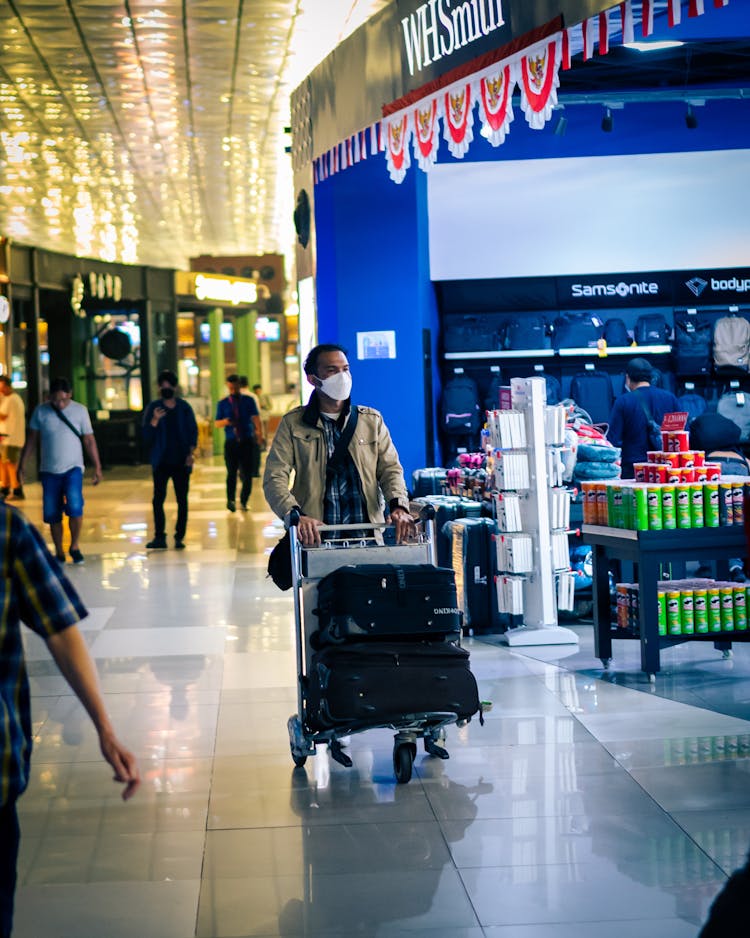 Man Walking On Airport Corridor