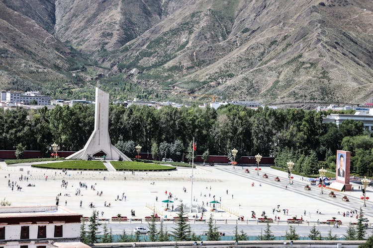 Monument In A Square With Mountains In The Distance