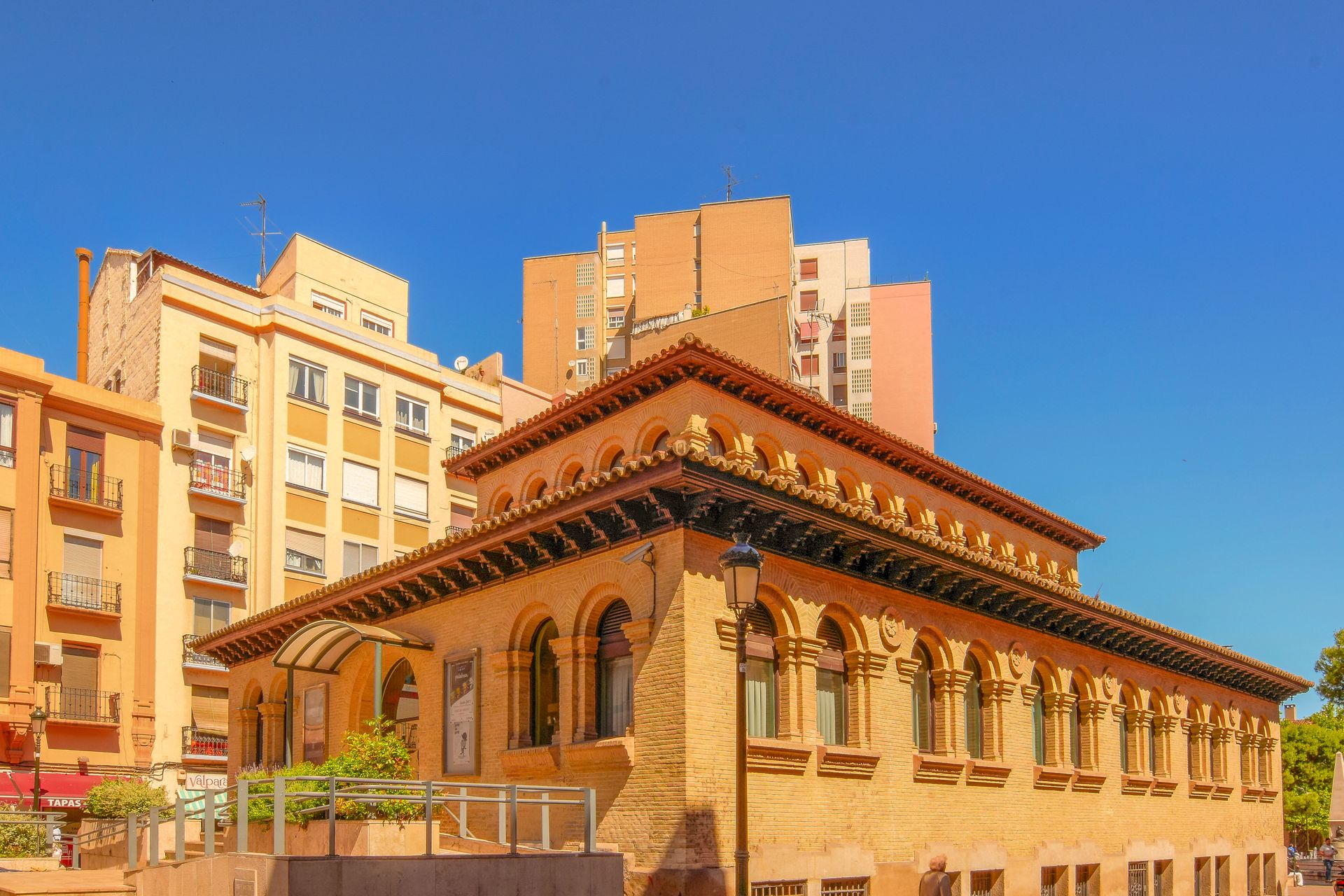 Explore the captivating architecture of Teatro del Mercado in Zaragoza, Spain, under clear blue skies.