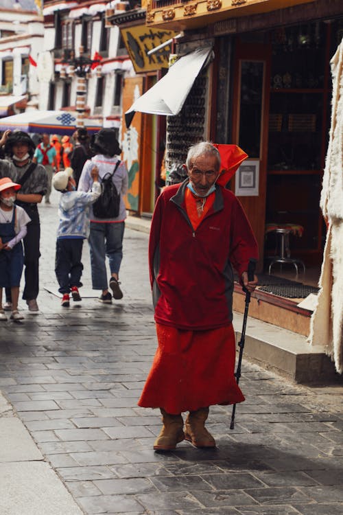 Elderly Buddhist Monk Walking in Town