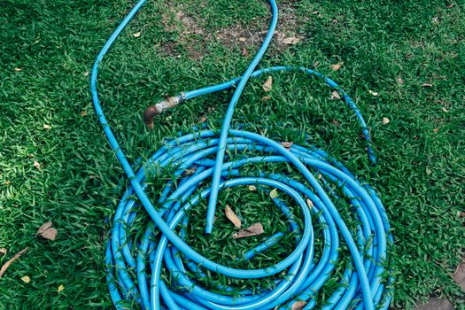 Blue Garden Hose on a Grass 