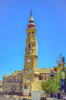 A beautiful view of a church tower in Zaragoza, capturing historical architecture under a clear blue sky.