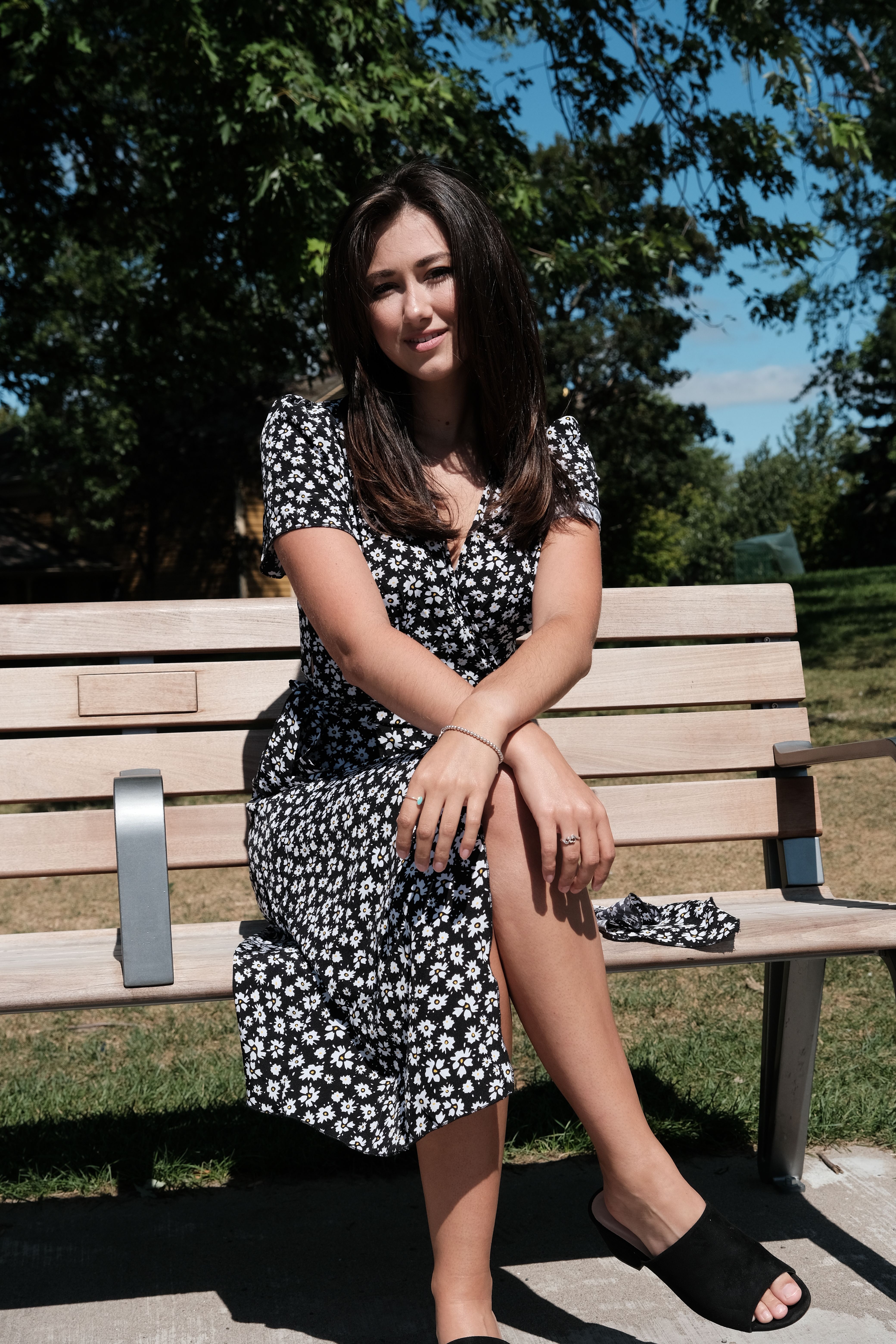 A Woman in a Floral Dress Sitting on a Bench · Free Stock Photo