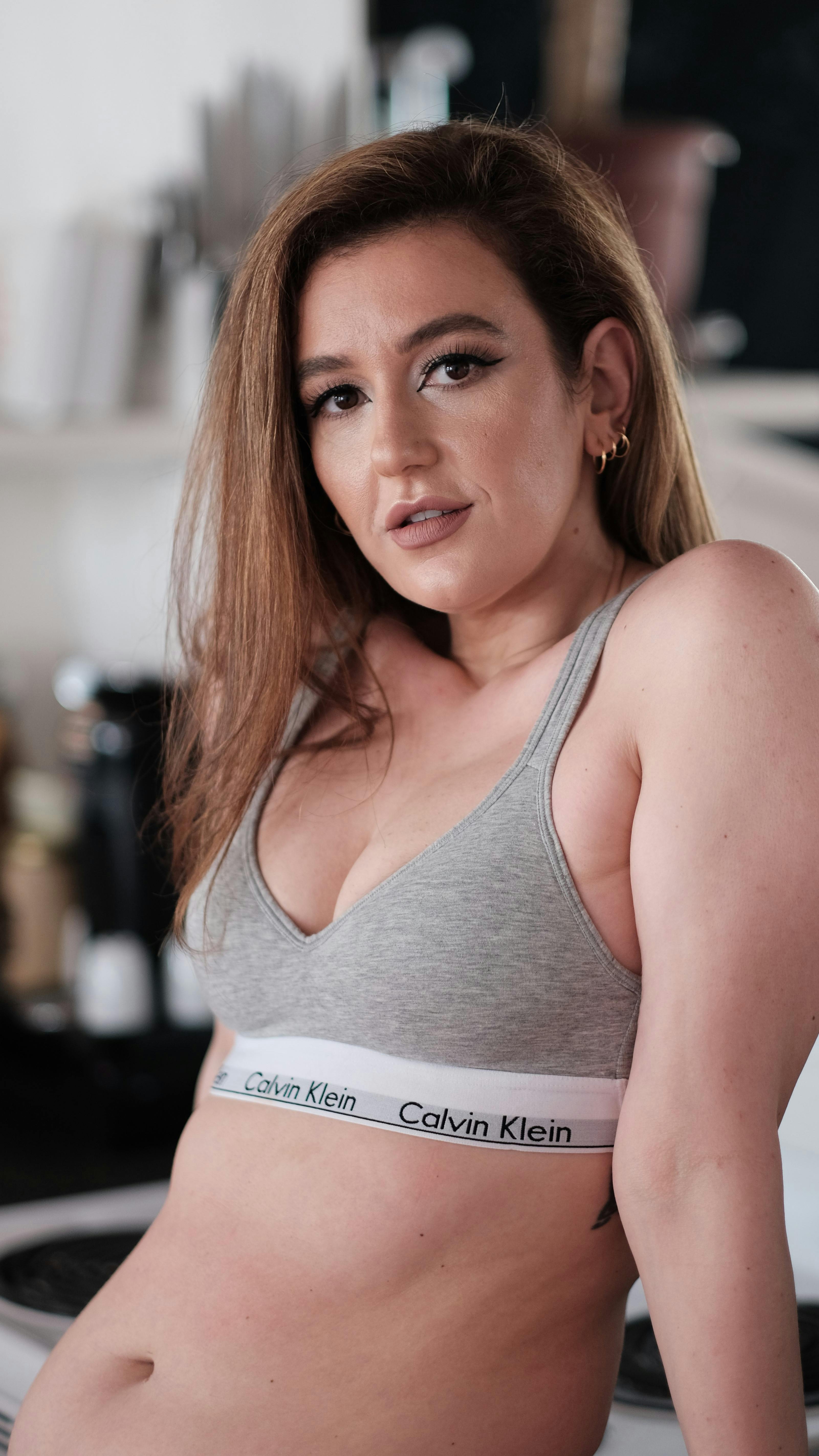 A Woman Wearing a Gray Calvin Klein Bra · Free Stock Photo