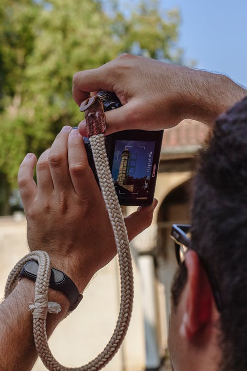 A Man Taking a Picture of the Grand Mosque with His Camera