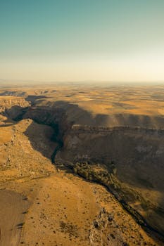 Explore the vast, arid landscape of a majestic desert canyon captured from above.
