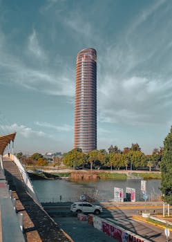 View of the Eurostars Torre Sevilla, a modern high-rise building in Seville, Spain.