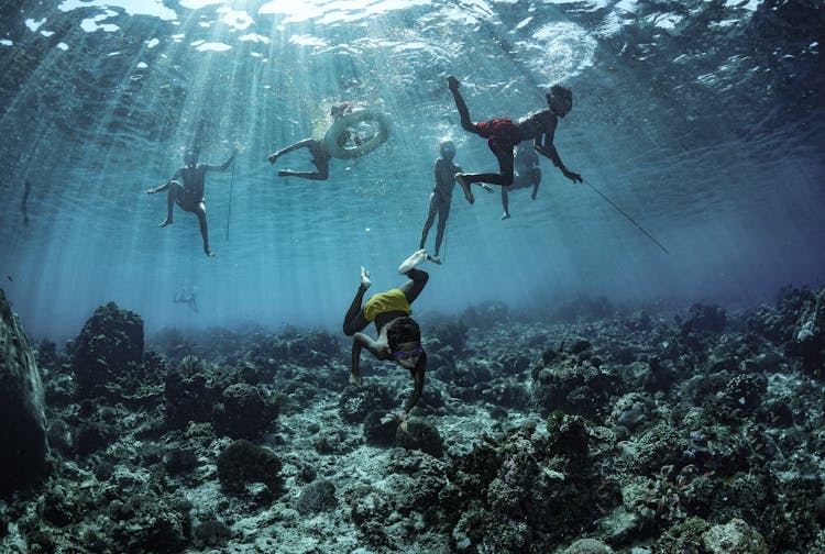 People Doing A Freediving Underwater 