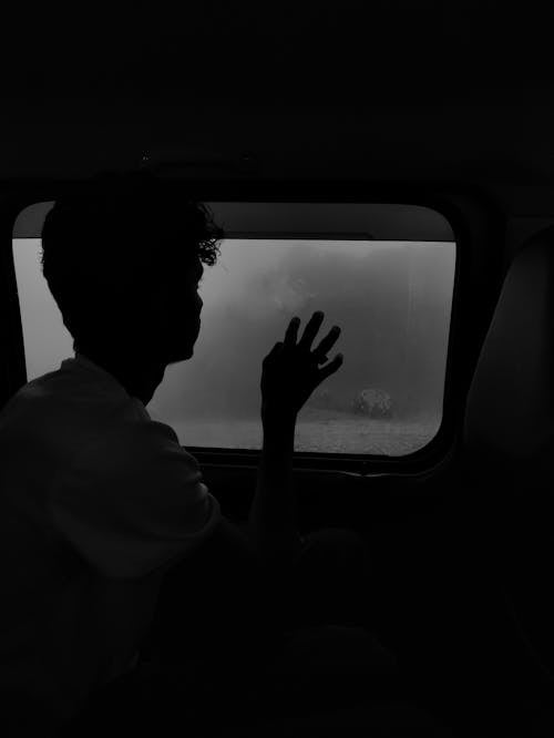 Silhouette of Man by the Window 