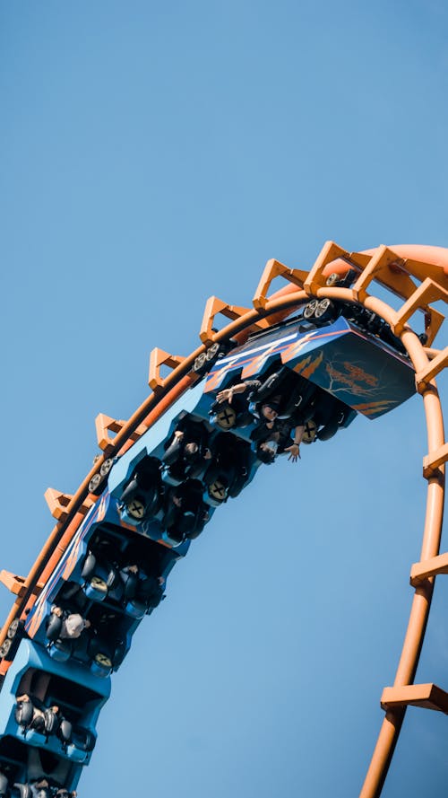 Low Angle Shot of People Riding on Roller Coaster