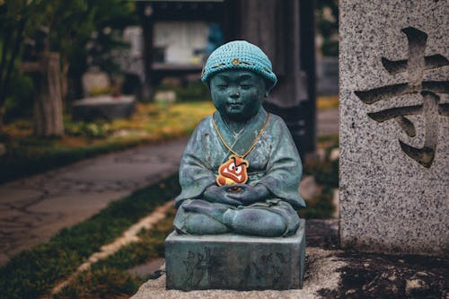 Close-up Photo of Buddhist Sculpture 