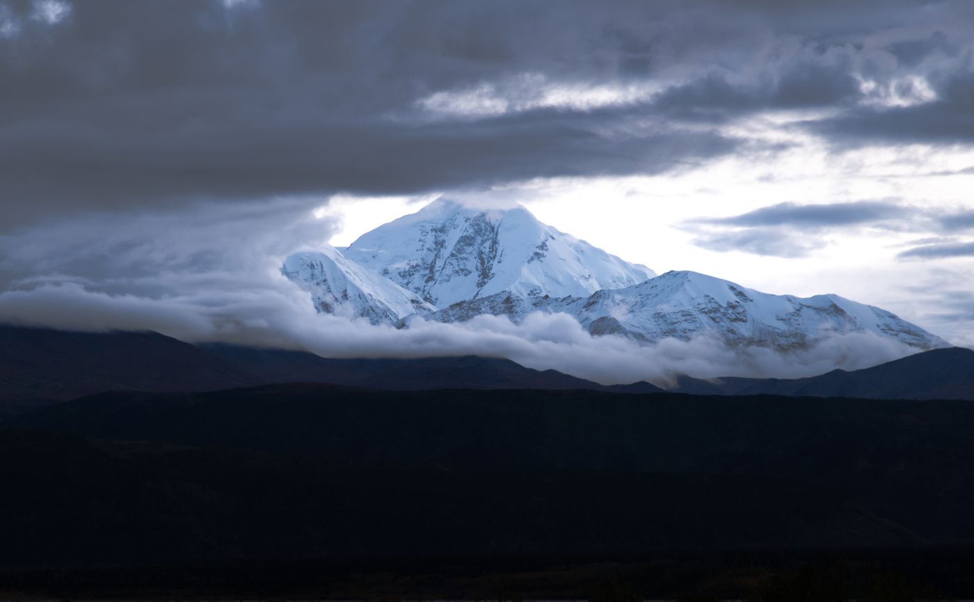 Denali's snow-covered summit in Alaska revealed as cloud parts around it